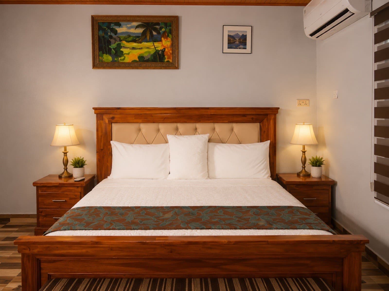 A refined double room at JC Guest House with a king bed and bedside lamps